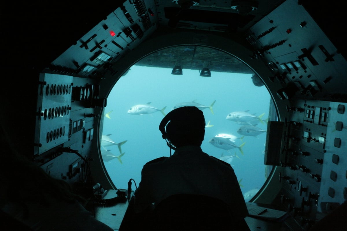 An Atlantis submarine surfacing off the Hawaii coast, a dry way for non-swimmers to see the reef