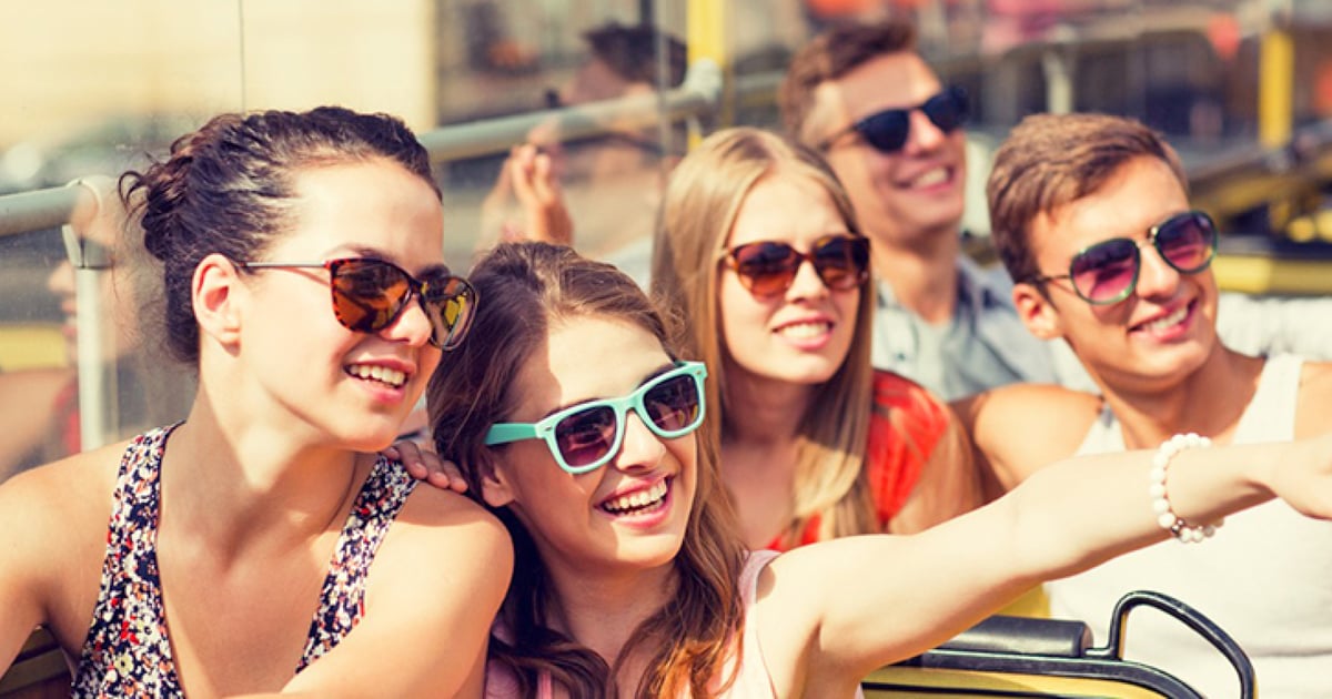 Travelers sightseeing together on an open-air guided tour
