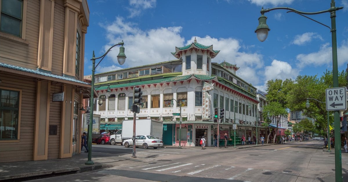The historic Wo Fat building with its green tiled pagoda-style roof on a Chinatown street corner in Honolulu