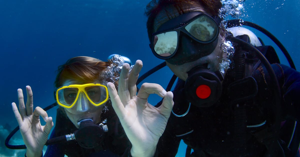 Scuba diver swimming above a reef in Kauaʻi waters
