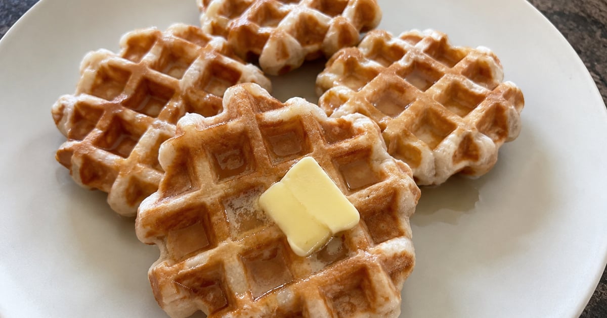 A stack of Hawaii mochi waffles with coconut syrup and toasted coconut