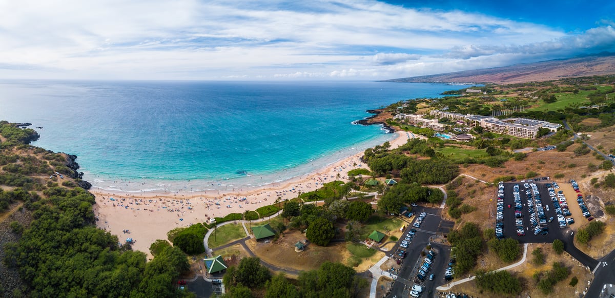Aerial view of Hapuna Beach State Recreation Area with beach, parking, lawns, and resort coastline.