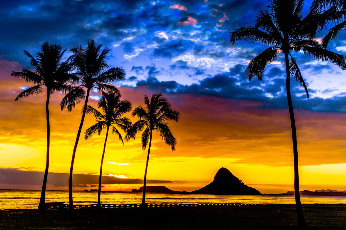 Mokoli'i (Chinaman's Hat) at sunrise off Oahu's windward shore, viewed from the water.