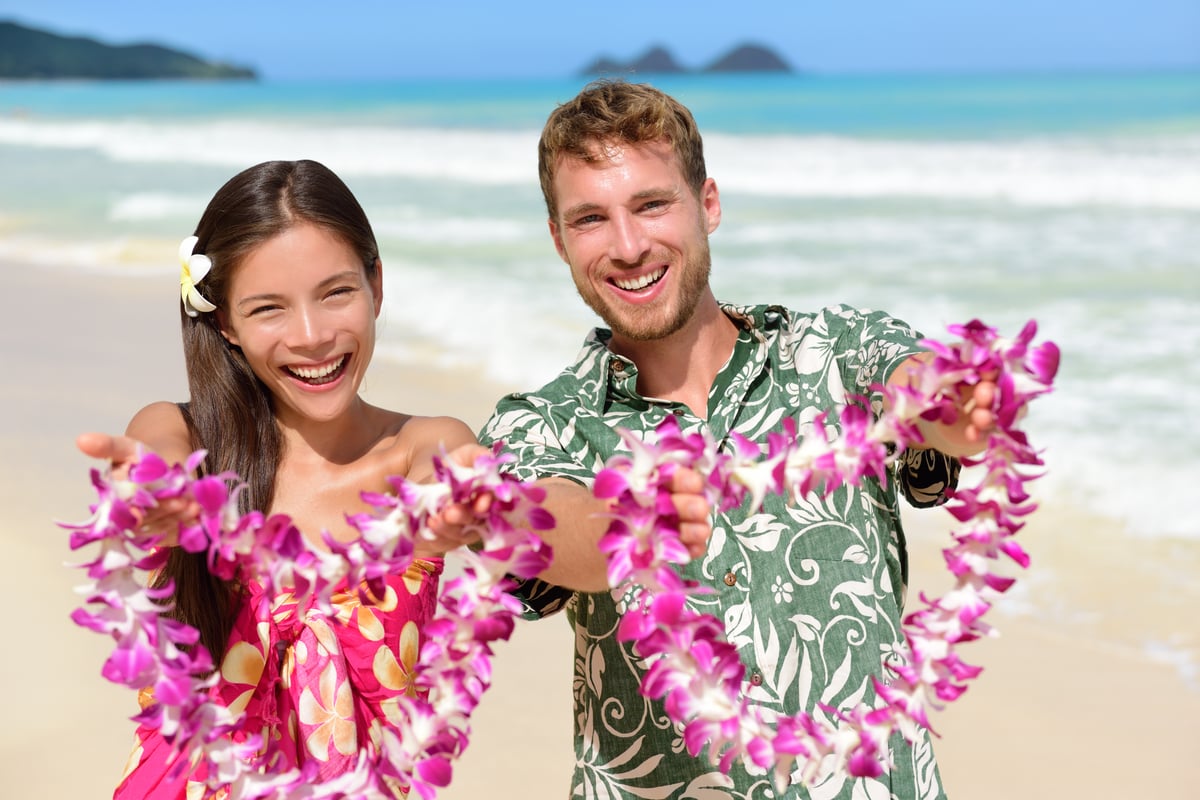 A visitor receiving a fresh flower lei on arrival in Hawaiʻi