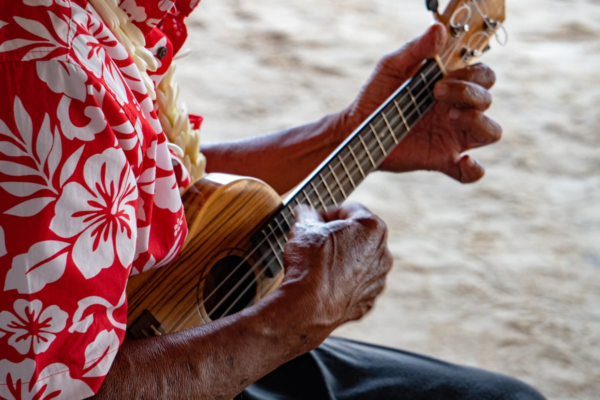 Slack-key guitar and ʻukulele performance in soft light — the kind of Hawaiian music featured in the Mokihana Festival composers contest