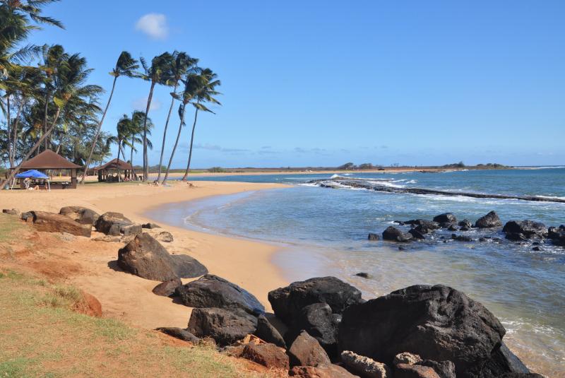 Salt Pond Beach Park on Kauai with sandy shoreline and protected water.