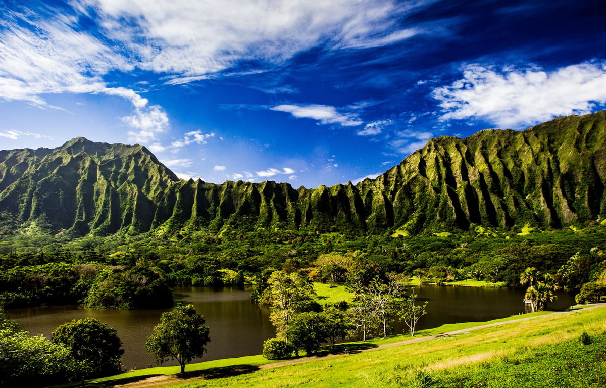 Green Koʻolau cliffs above the lake at Hoʻomaluhia Botanical Garden on Oʻahu