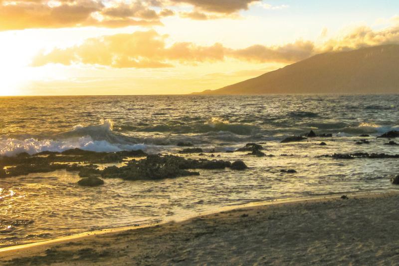 Kamaole Beach Park on Maui with bright sand, blue water, and park space behind the beach.