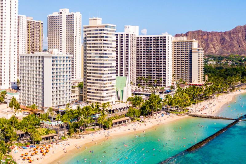 Waikiki hotel towers beside the beach with Diamond Head in the background