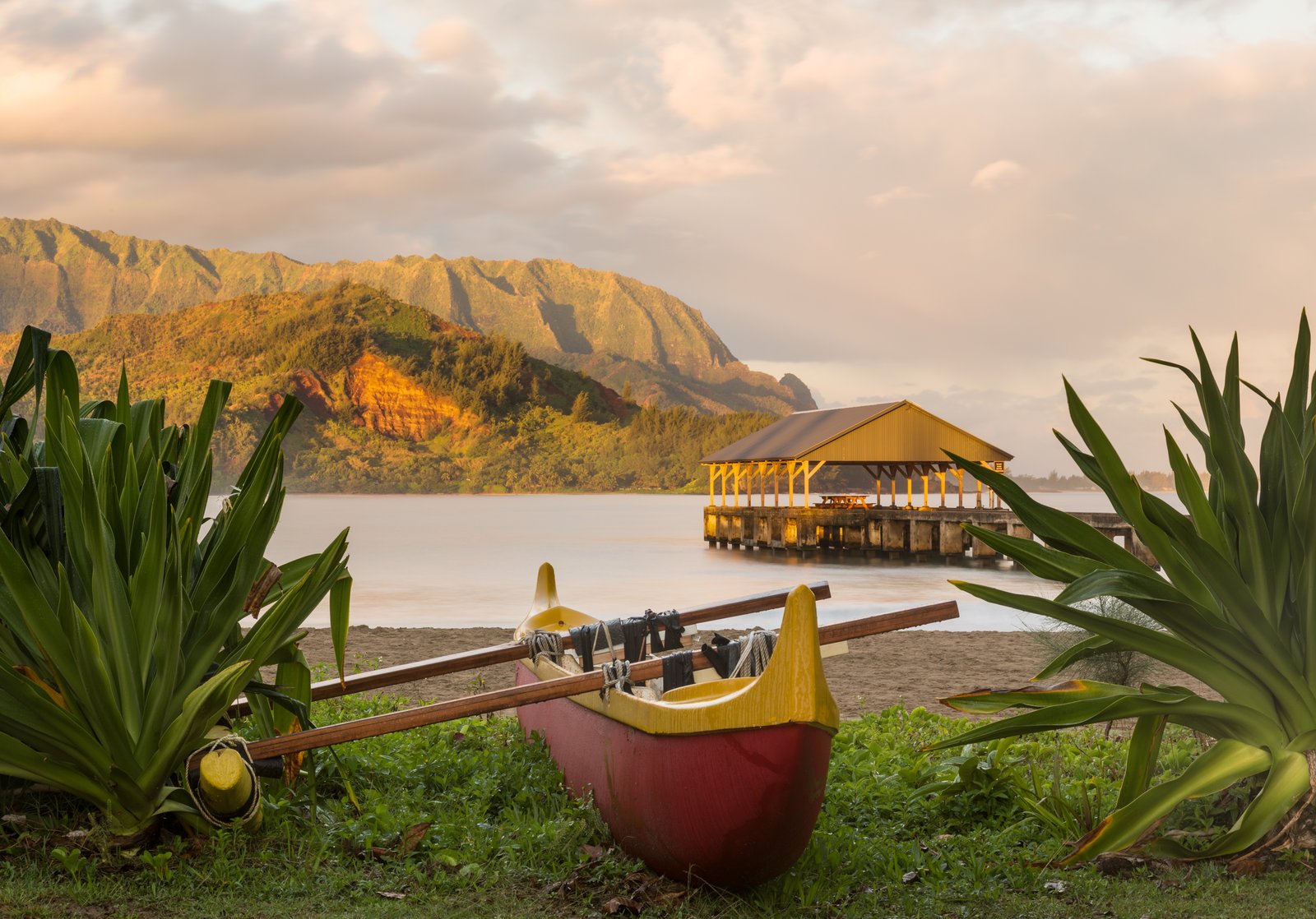 Hanalei Bay and its pier on Kauai's north shore, calm water ringed by green mountains