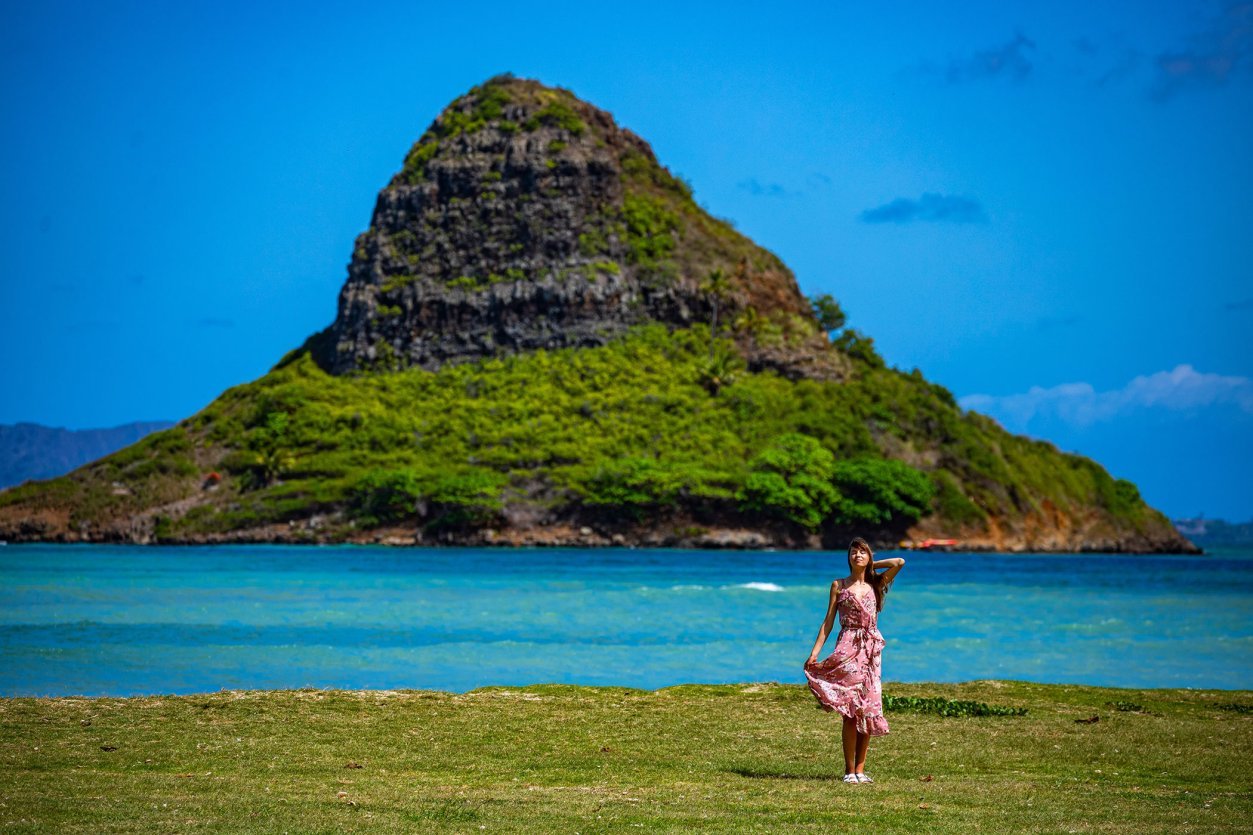 Kualoa Regional Park on the windward side of Oʻahu, looking out across the bay to Mokoliʻi (Chinaman's Hat). A classic spot for an outdoor afternoon — and the kind of trailhead where geocaches tend to hide.