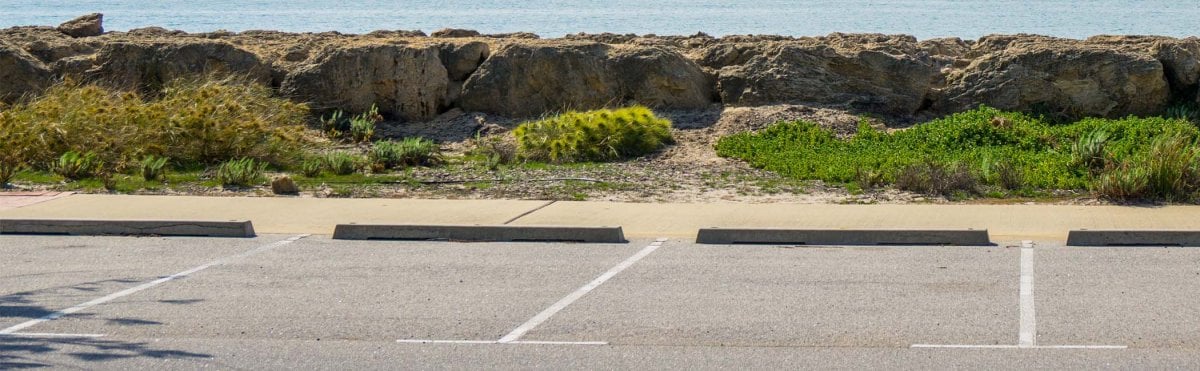 Marked PARK MAUI beach parking spaces near the Maui shoreline.