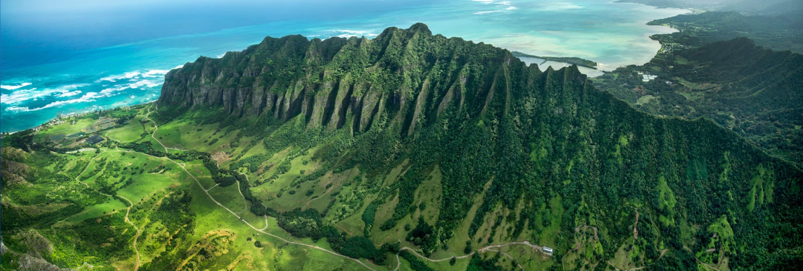 Aerial view of Kualoa Ranch's Kaʻaʻawa Valley on Oʻahu's windward coast — the setting for ATV, jungle expedition, and movie-site combo tours