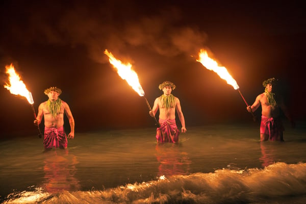 Fire-knife dancers performing at night at a Hawaii luau