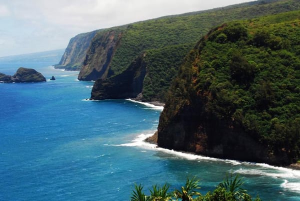 Green sea cliffs meeting blue ocean at Pololū Valley, Big Island