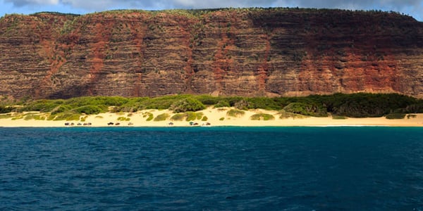 Sand backed by towering cliffs at Polihale State Park on Kauaʻi's west end