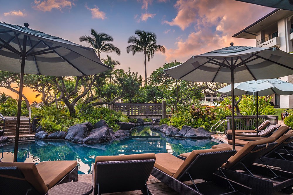 Sit and relax poolside at the Grand Hyatt Kauai Resort & Spa