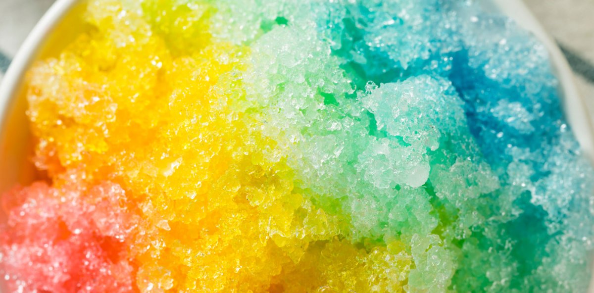 Colorful Hawaiian shave ice topped with tropical syrups Tile Image