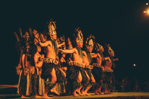 Large group of hula dancers dancing at night in Honolulu Hawaii for a cheap activity to do.