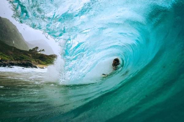 A person surfing waves at Waimanalo Beach, one of the most popular beaches to visit in Hawaii