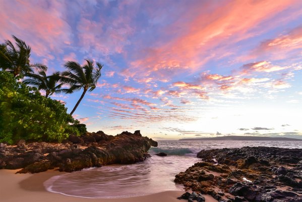 Water and beach during sunset at Secret Cove Beach in Maui