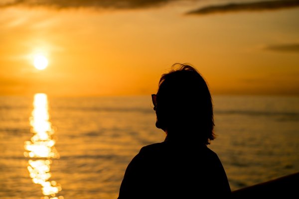 Woman overlooking the water during sunset in Maui